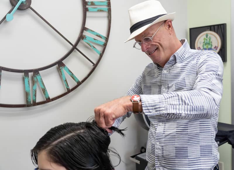 Greg Salter cutting a client's hair at Oz Hair Studio in Waco, TX